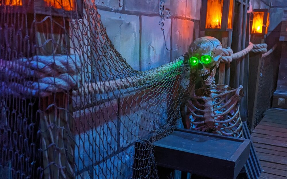 A skeleton prop with green glowing eyes