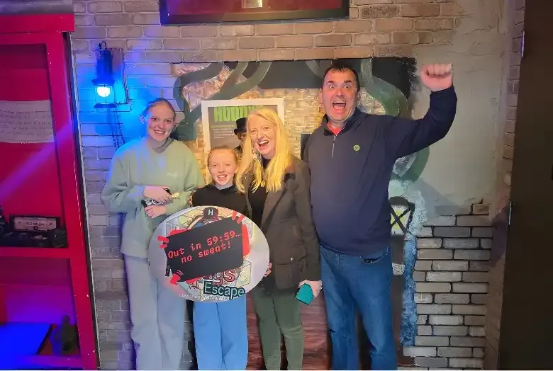 People holding a finished escape sign