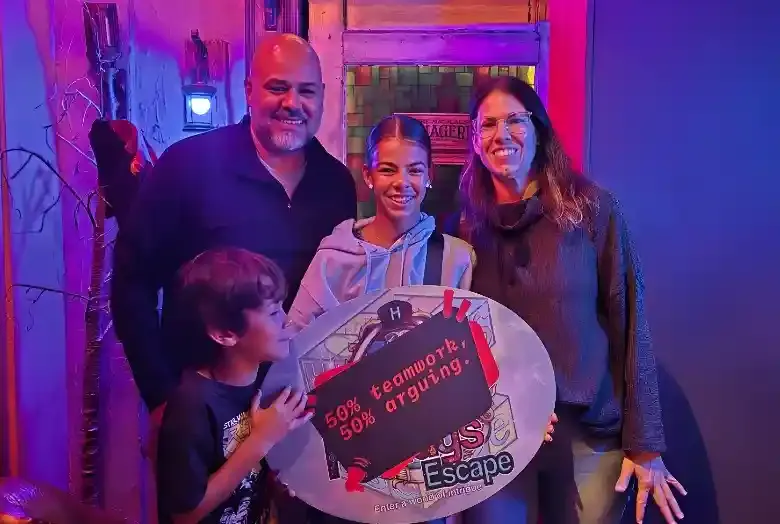 People holding a finished escape sign